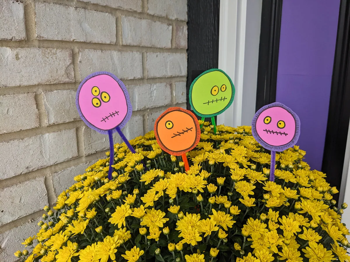 DIY Halloween floral picks with a silly monster faces in front porch mums