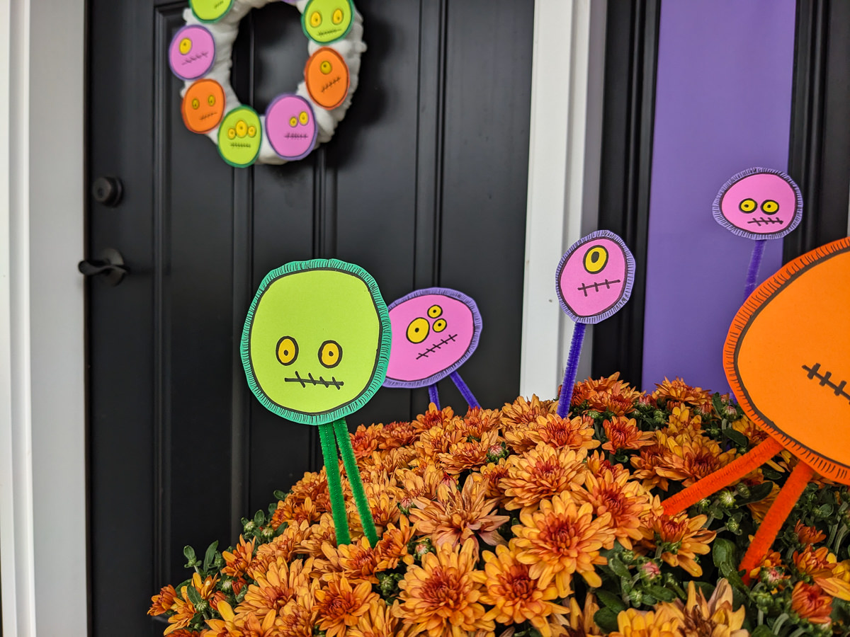 DIY Halloween floral picks with a silly monster faces in front porch mums