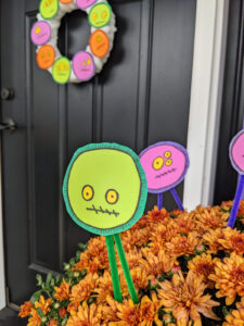 DIY Halloween floral picks with a silly monster faces in front porch mums