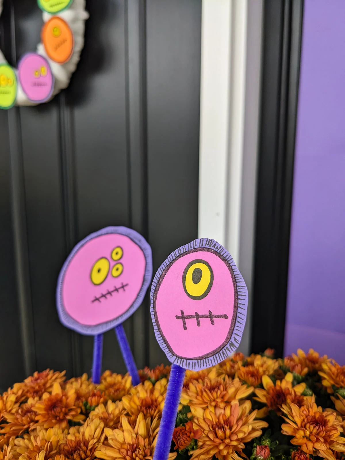 DIY Halloween floral picks with a silly monster faces in front porch mums