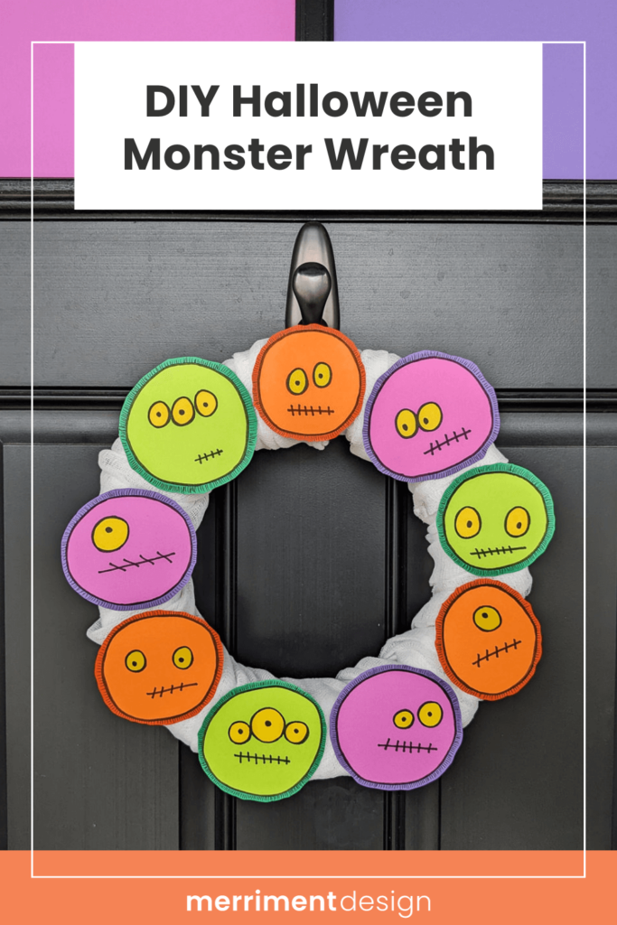 DIY Halloween Monster Wreath in purple, green, and orange on a black front door