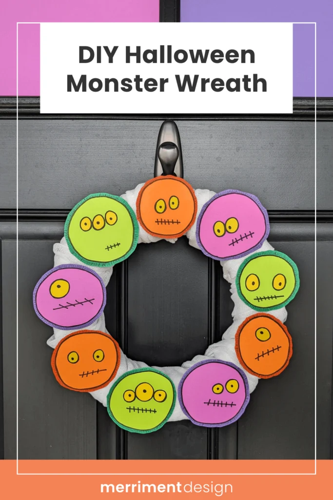 DIY Halloween Monster Wreath in purple, green, and orange on a black front door