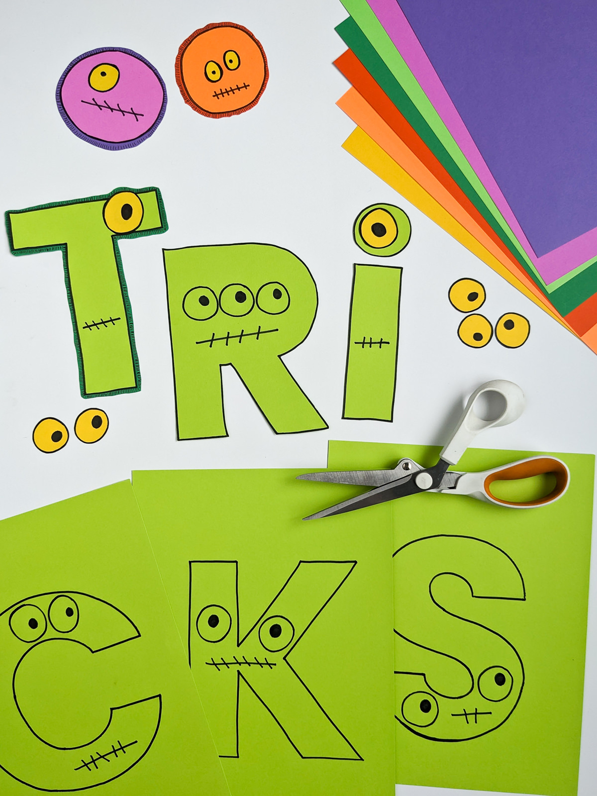 Printable Halloween banner that spells Tricks. Each letter has monster eyes.