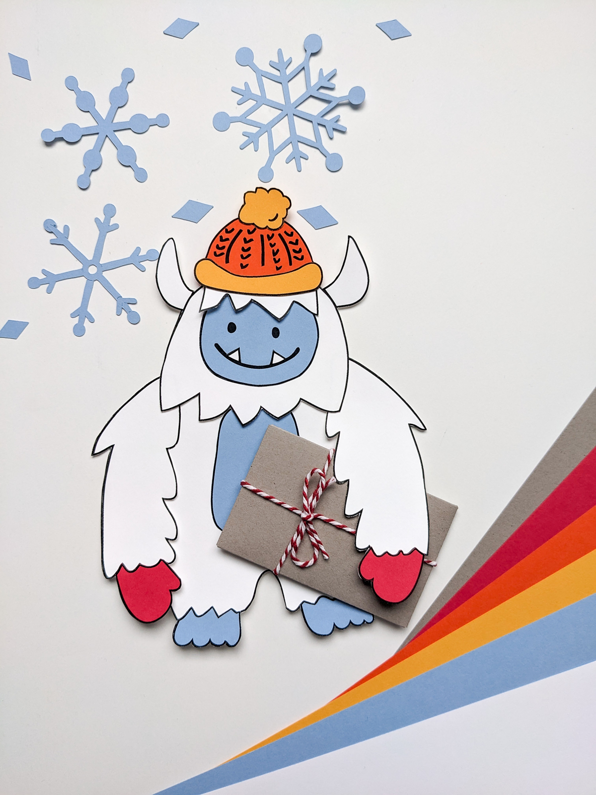 Paper Yeti featuring an abominable snowman holding a gift card