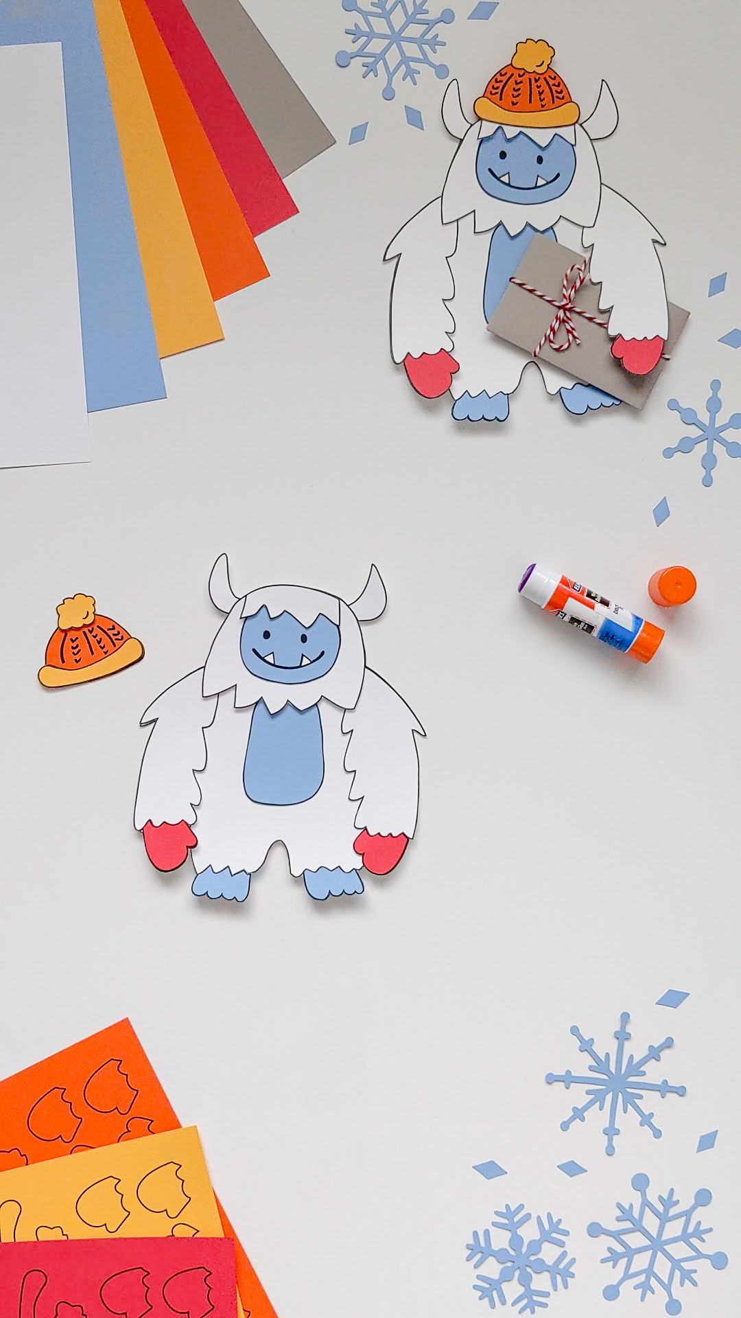 Gluing together a paper Yeti Abominable Snowman craft using a glue stick